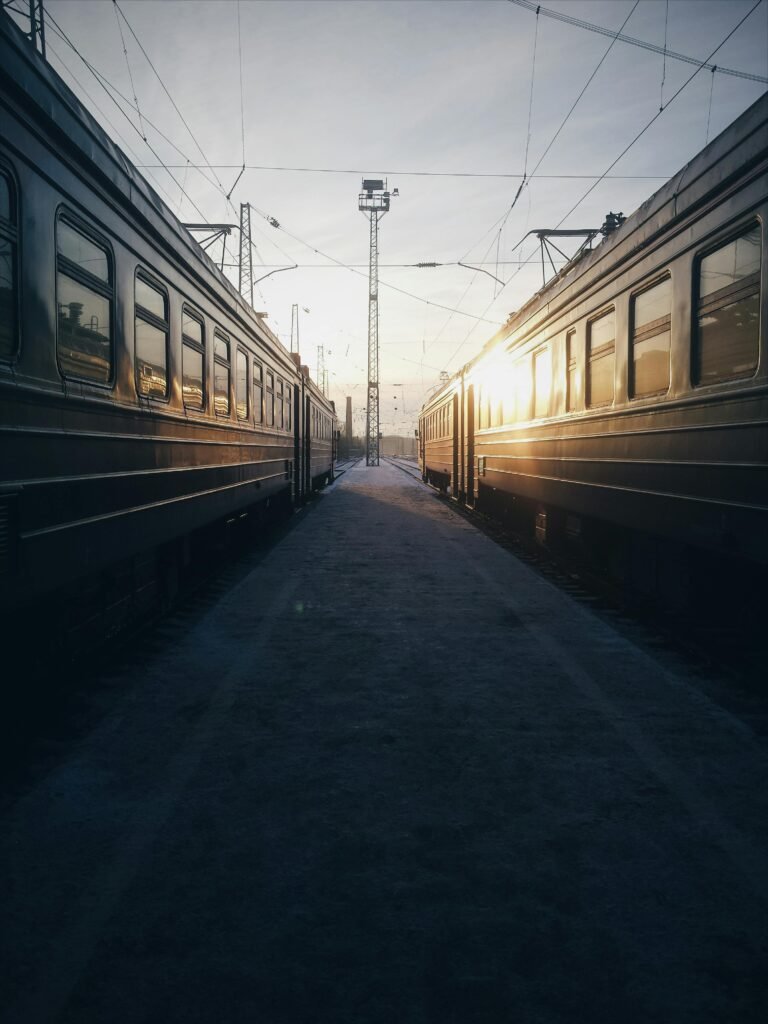 pexels-photo-1771670-1771670 Sunrise between two trains at an empty station, showcasing railway symmetry.
